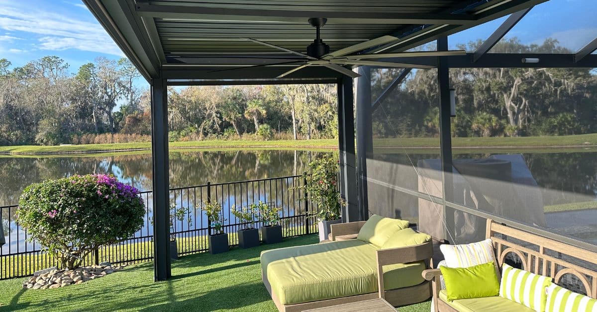 Interior view of aluminum pergola with adjustable roof panels and ceiling fan