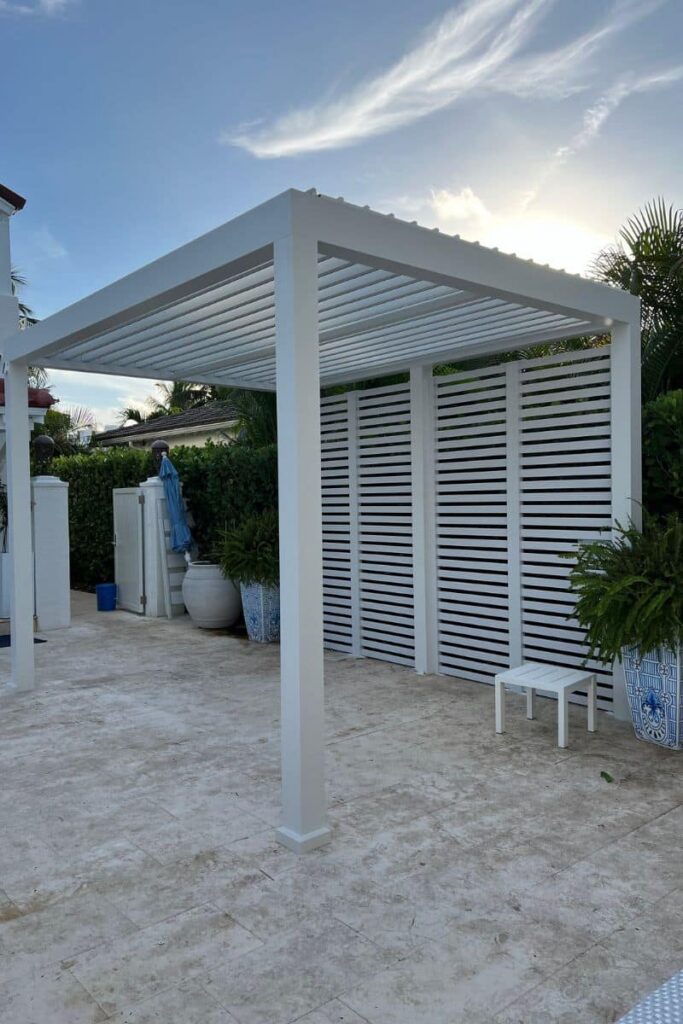 White wind resistant pergola with adjustable louvered roof system