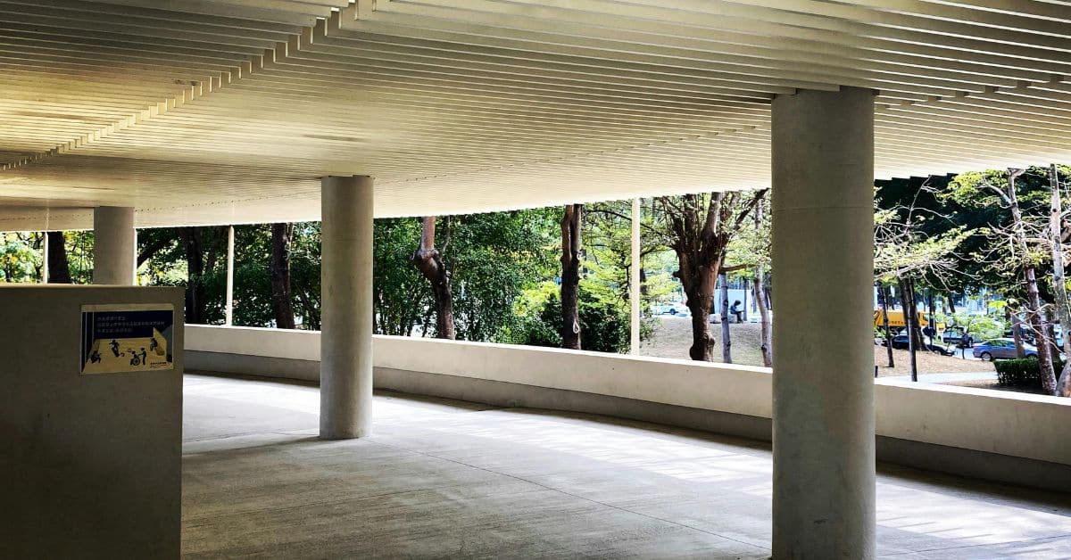 Wall mounted pergola with roof covering an outdoor walkway